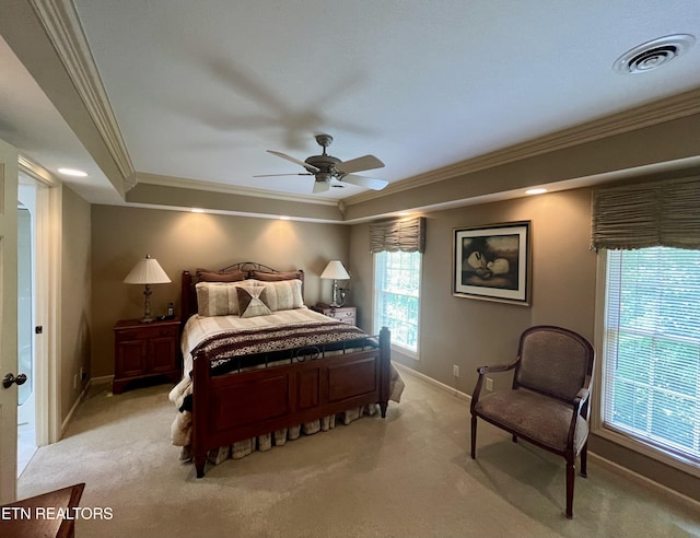 bedroom featuring crown molding, light colored carpet, baseboards, a ceiling fan, and a raised ceiling