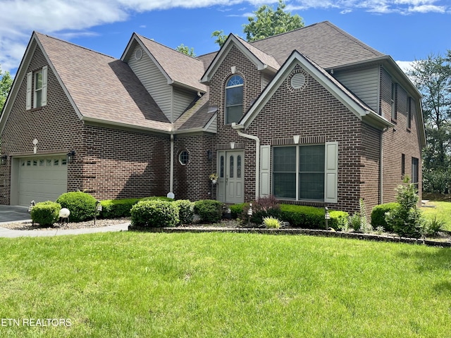 traditional-style house featuring brick siding, a front yard, and a shingled roof