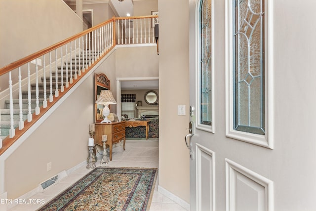 704 Blue Dun Ct, Pigeon Forge, TN 37863 - tiled entrance foyer featuring stairs, baseboards, and a towering ceiling