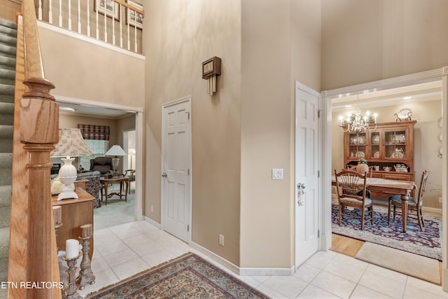 704 Blue Dun Ct, Pigeon Forge, TN 37863 - tiled foyer with a towering ceiling, stairway, a chandelier, baseboards, and ornamental molding