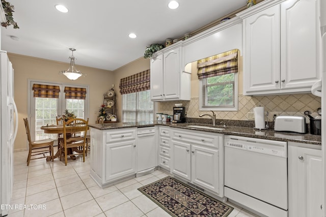 704 Blue Dun Ct, Pigeon Forge, TN 37863 - kitchen with white appliances, a sink, a peninsula, white cabinets, and tasteful backsplash