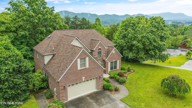 704 Blue Dun Ct, Pigeon Forge, TN 37863 - traditional-style home with an attached garage, brick siding, driveway, a front lawn, and a mountain view