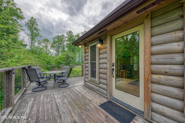 wooden deck featuring outdoor dining space
