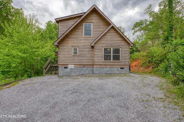 rear view of house featuring crawl space, log exterior, and stairs