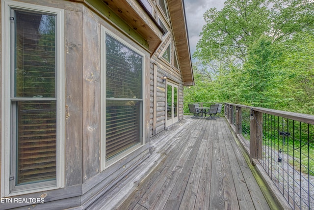 wooden terrace with outdoor dining area