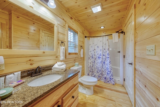 full bathroom featuring wood finished floors, toilet, a shower with shower curtain, wood walls, and vanity