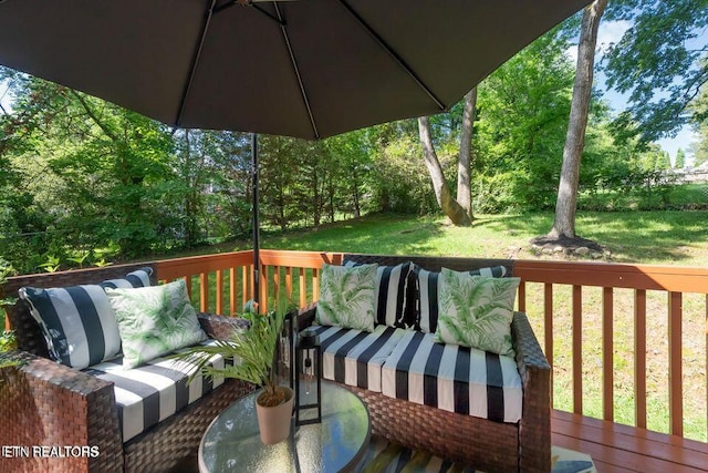 deck with an outdoor living space and a yard