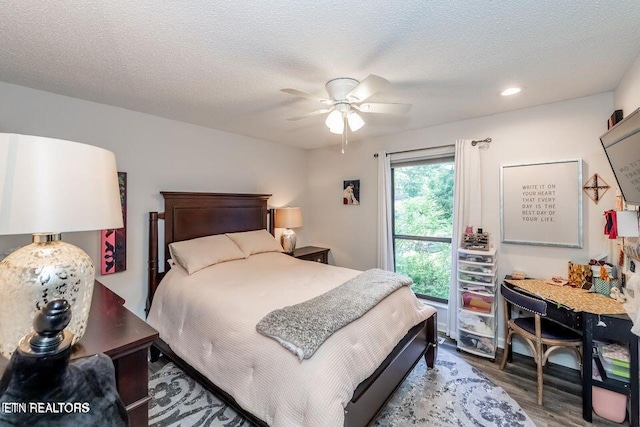 bedroom with a ceiling fan, recessed lighting, a textured ceiling, and wood finished floors