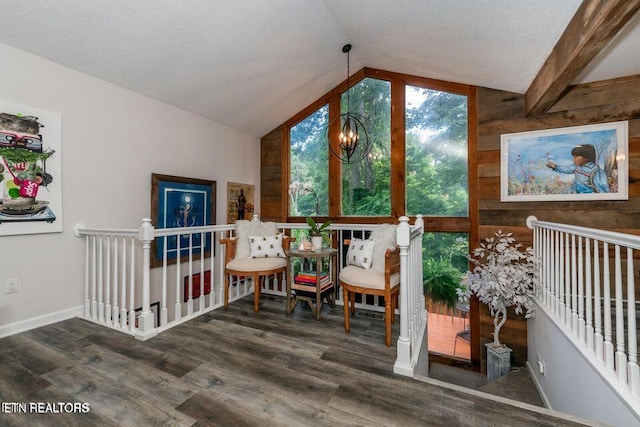 bonus room with vaulted ceiling, an inviting chandelier, baseboards, and wood finished floors
