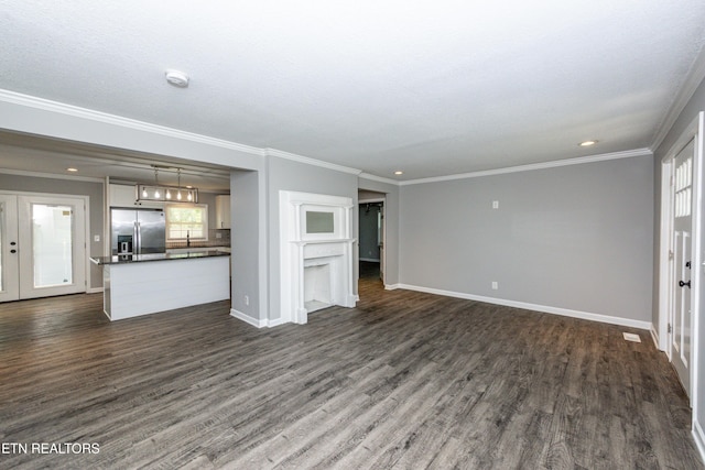 2208 Sanderson Rd, Knoxville, TN 37921 - unfurnished living room featuring french doors, crown molding, dark wood finished floors, baseboards, and recessed lighting