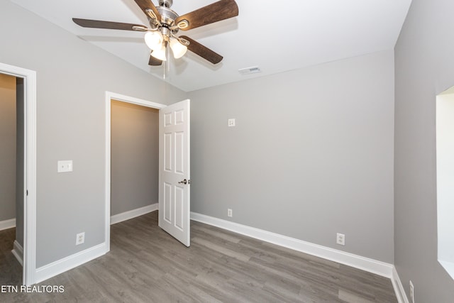 2208 Sanderson Rd, Knoxville, TN 37921 - unfurnished bedroom featuring wood finished floors, visible vents, vaulted ceiling, a ceiling fan, and baseboards
