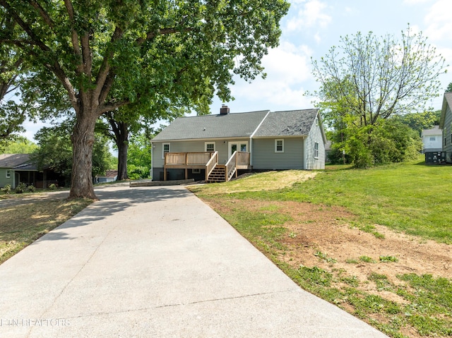 2208 Sanderson Rd, Knoxville, TN 37921 - view of front of house featuring a front yard, driveway, a chimney, and a wooden deck
