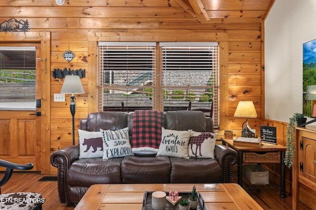 living area featuring wooden walls, hardwood / wood-style flooring, healthy amount of natural light, wooden ceiling, and beam ceiling