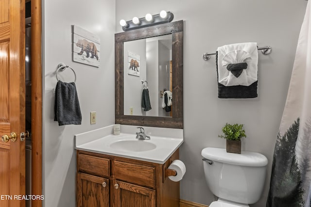 bathroom featuring toilet and vanity