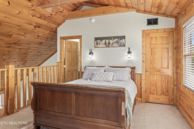 bedroom with vaulted ceiling, light colored carpet, a wainscoted wall, wood walls, and wood ceiling