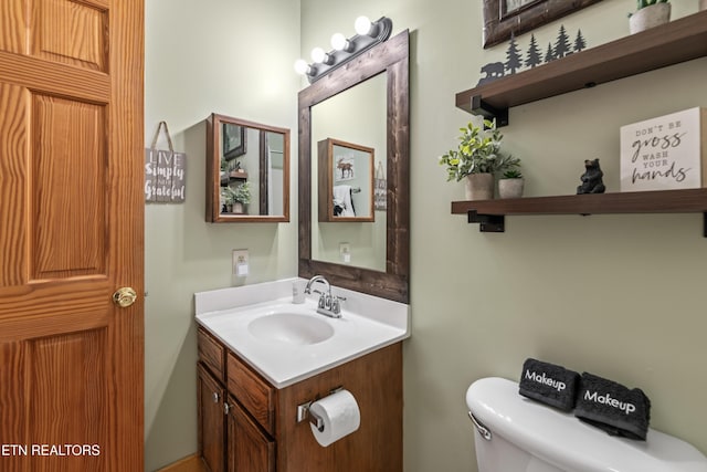 bathroom featuring toilet and vanity