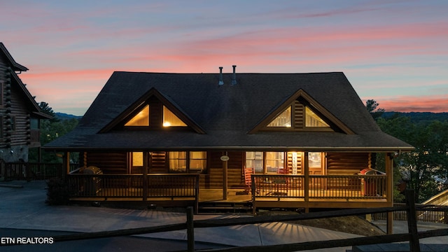 log home featuring a deck, roof with shingles, french doors, and log exterior