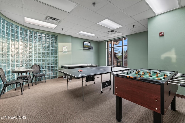 game room with carpet flooring and a drop ceiling