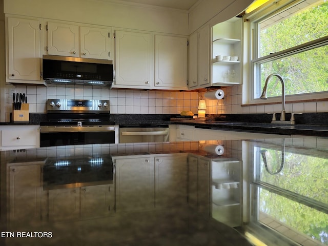 8008 Sharp Rd, Powell, TN 37849 - kitchen featuring a sink, dark countertops, stainless steel appliances, white cabinets, and backsplash
