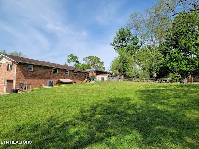 8008 Sharp Rd, Powell, TN 37849 - view of yard featuring central air condition unit, fence, and a garage