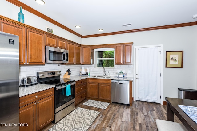 229 Bishops Cap Cir Unit 106, Townsend, TN 37882 - kitchen featuring appliances with stainless steel finishes, a sink, tasteful backsplash, ornamental molding, and dark wood-style flooring