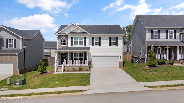 view of front of home featuring a porch, a garage, concrete driveway, and a front lawn