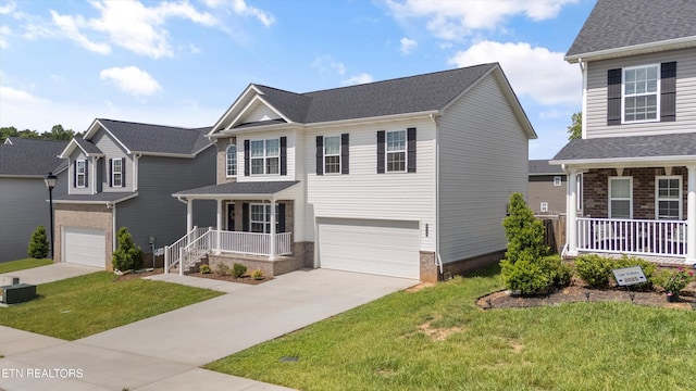 view of front facade with covered porch, concrete driveway, an attached garage, a front lawn, and brick siding