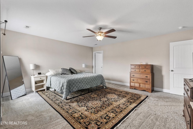 bedroom with light colored carpet, baseboards, and ceiling fan