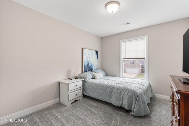 bedroom with light carpet and baseboards