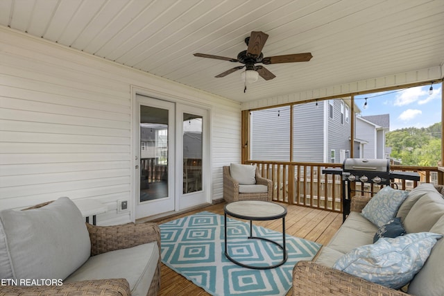 sunroom / solarium with a ceiling fan and outdoor lounge area