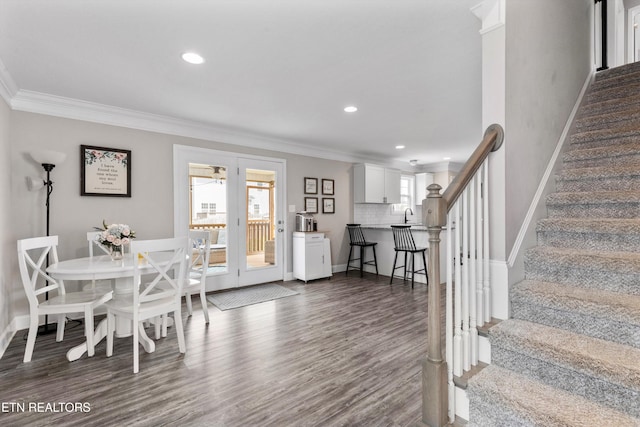 dining area with baseboards, crown molding, dark wood-style flooring, stairs, and recessed lighting