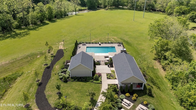 aerial view of property and surrounding area featuring a pool