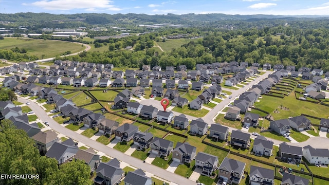 aerial view of property's location featuring a mountain backdrop and nearby suburban area
