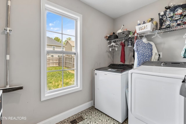 washroom featuring plenty of natural light, separate washer and dryer, and baseboards