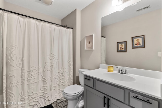 bathroom with vanity, toilet, and a shower with shower curtain