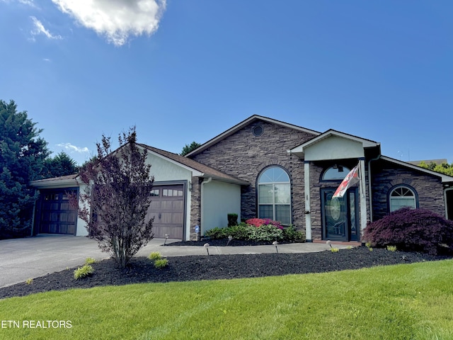 ranch-style home with a front lawn, stone siding, a garage, and concrete driveway