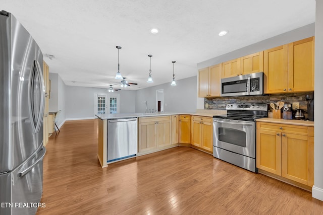 791 Constitution Dr, Jefferson City, TN 37760 - kitchen with stainless steel appliances, a peninsula, light brown cabinetry, ceiling fan, and decorative backsplash