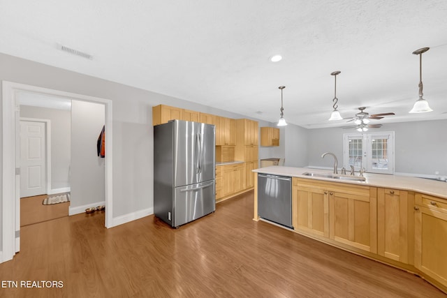 791 Constitution Dr, Jefferson City, TN 37760 - kitchen with appliances with stainless steel finishes, a sink, light brown cabinetry, a ceiling fan, and light countertops