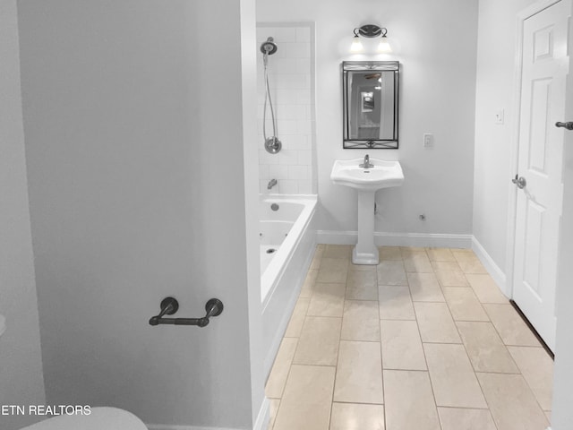 bathroom with shower / bath combination, tile patterned flooring, and baseboards
