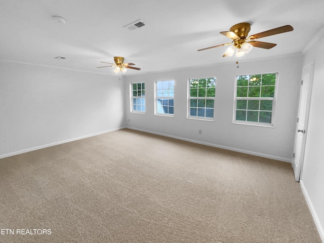 spare room with ceiling fan, light carpet, baseboards, and ornamental molding