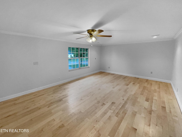 spare room featuring baseboards, ornamental molding, light wood finished floors, and ceiling fan