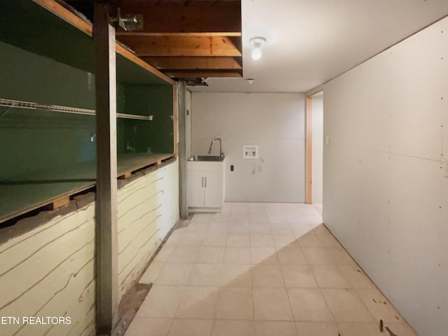 hallway with tile patterned floors and a sink
