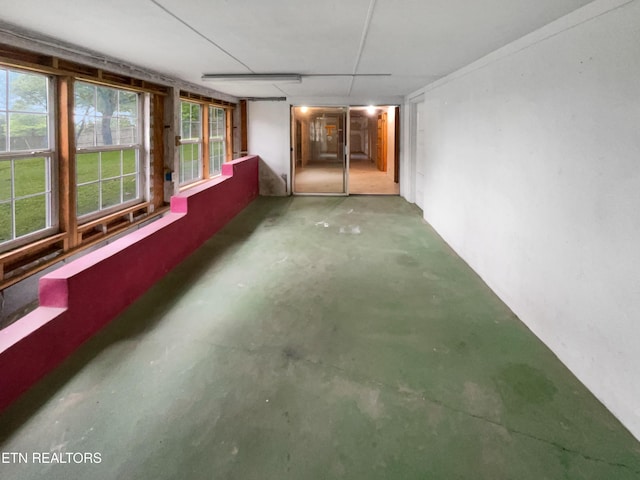unfurnished sunroom featuring concrete floors