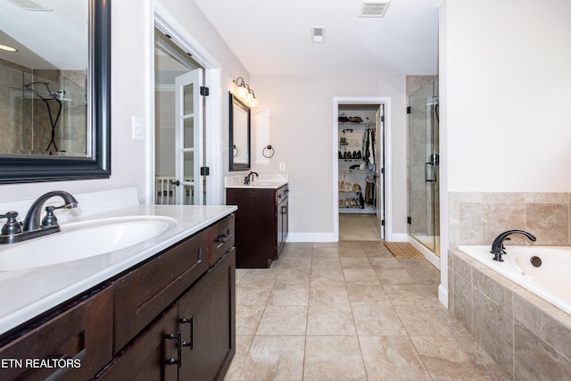 3336 Beaver Glade Ln, Knoxville, TN 37931 - bathroom with a stall shower, a walk in closet, a garden tub, two vanities, and tile patterned floors
