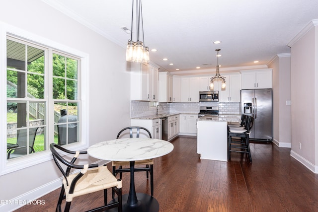 3336 Beaver Glade Ln, Knoxville, TN 37931 - kitchen featuring appliances with stainless steel finishes, backsplash, white cabinetry, a sink, and light stone countertops