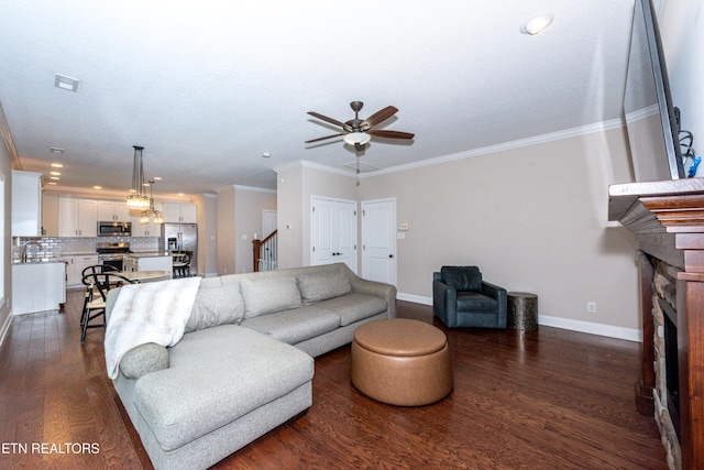 3336 Beaver Glade Ln, Knoxville, TN 37931 - living area featuring a stone fireplace, baseboards, dark wood-type flooring, crown molding, and a ceiling fan