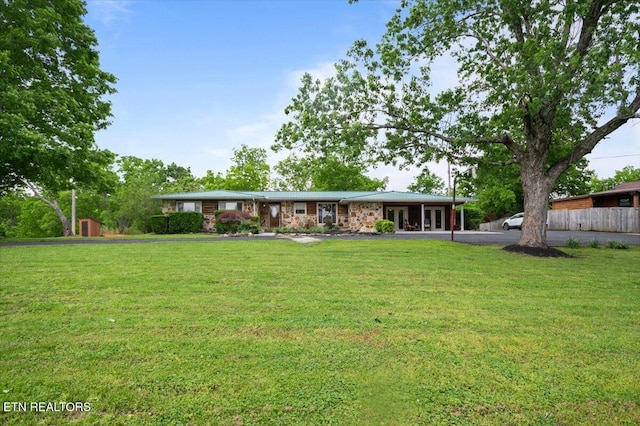 rear view of house featuring a lawn and french doors