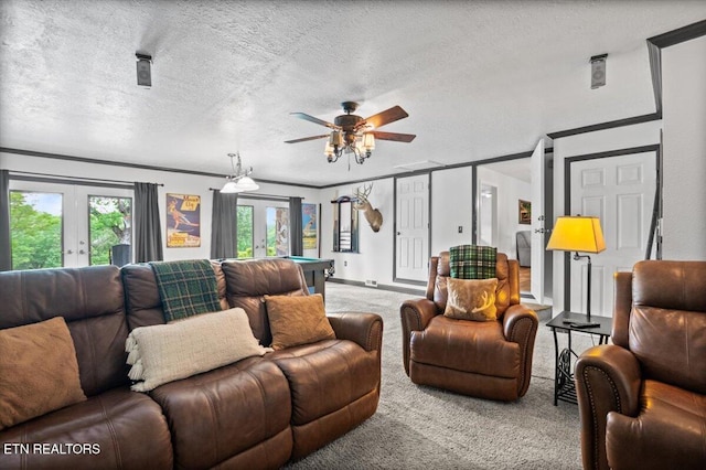 carpeted living area with french doors, crown molding, a textured ceiling, ceiling fan, and billiards