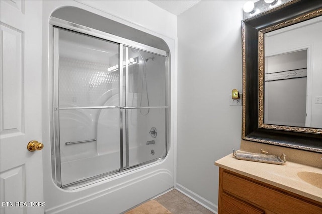 full bathroom featuring enclosed tub / shower combo, tile patterned flooring, vanity, and baseboards