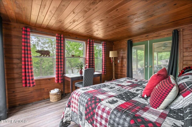 bedroom with wooden ceiling, wooden walls, and wood finished floors